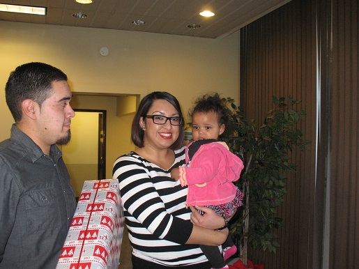 Gabriel and Brenda holding a small child